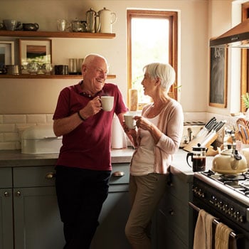 Man and woman talking in kitchen 